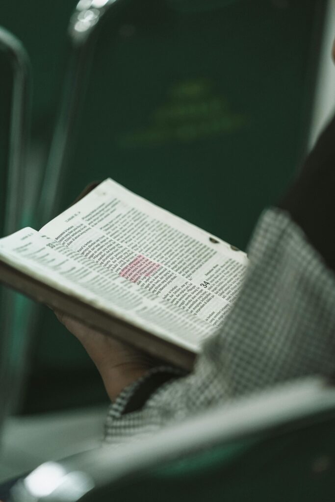 Person holding a Bible during a religious study session in West Java, Indonesia.